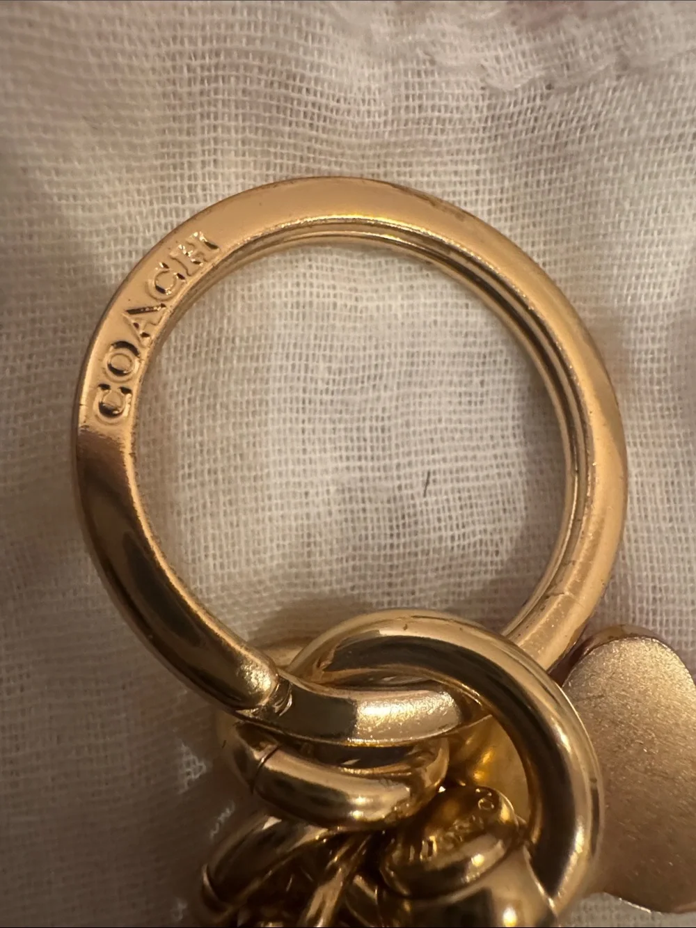 NWOT, Coach vintage gold “C” key fob/ bag charm in gold .
